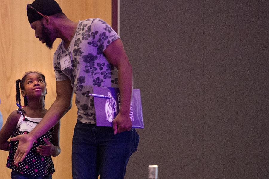  A father directs his daughter during an orientation.